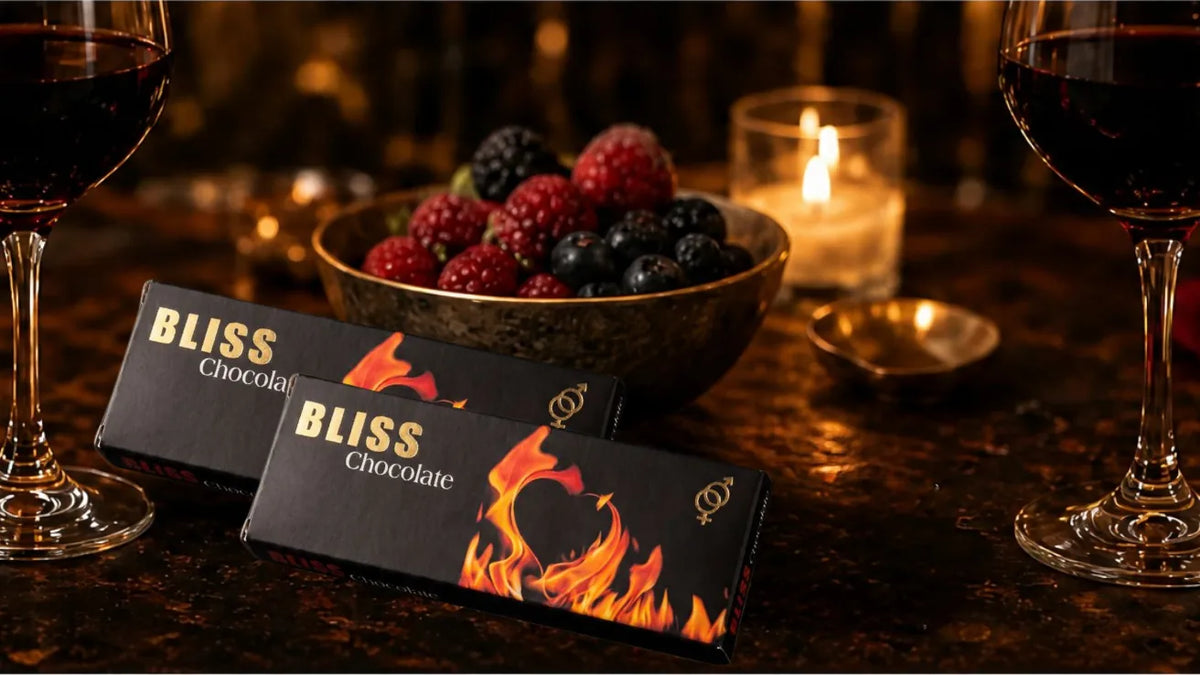 Warm candlelit bedroom setting with BLISS chocolate and wine.